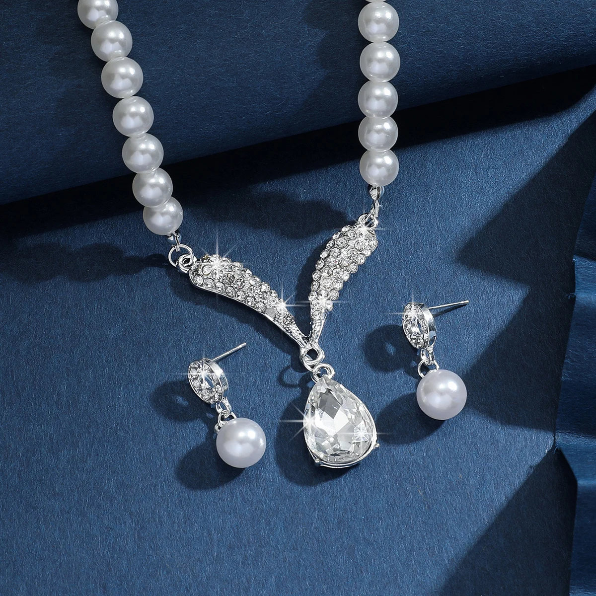 Gold jewelry set with pearl droplet necklace and matching earrings from Mohammad Collection, perfect for weddings and special events.